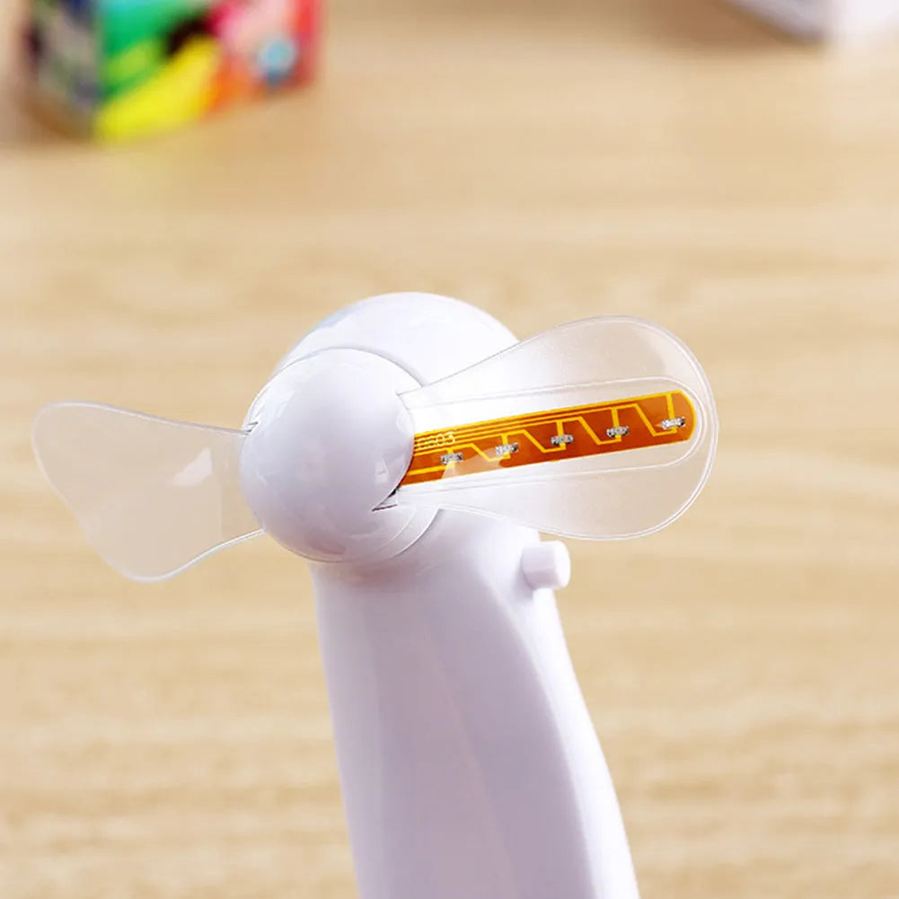 White handheld mini fan with blue and red LED 'I love you' flashing pattern on display.