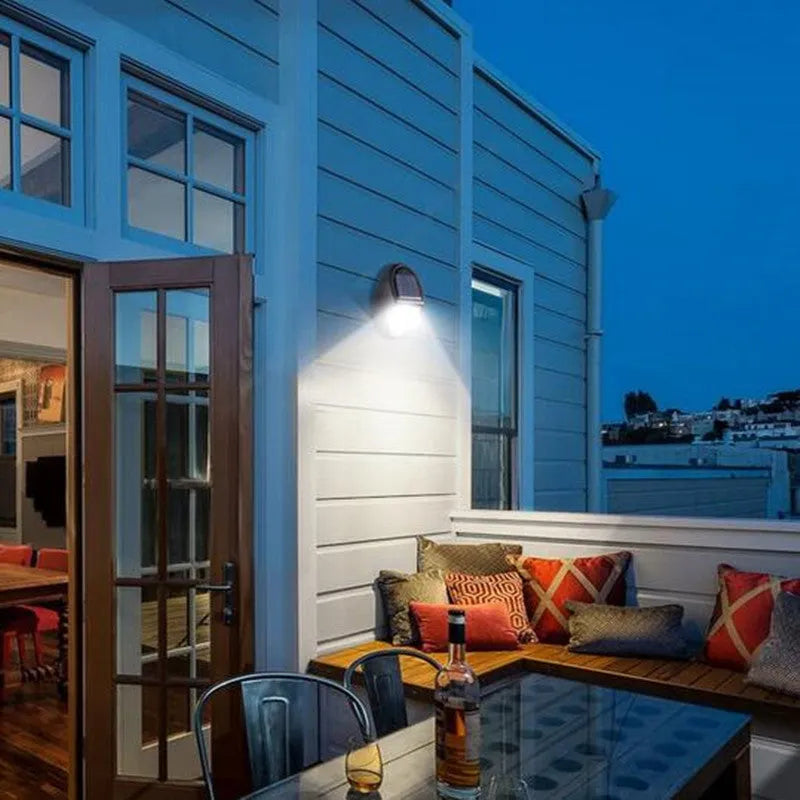 Black compact square solar-powered LED wall light for outdoor use.