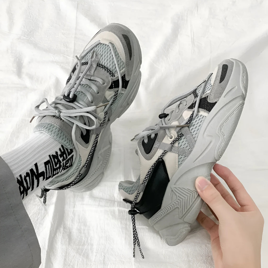 Men's white platform dad shoes with lace-up front and mesh lining on a neutral background.