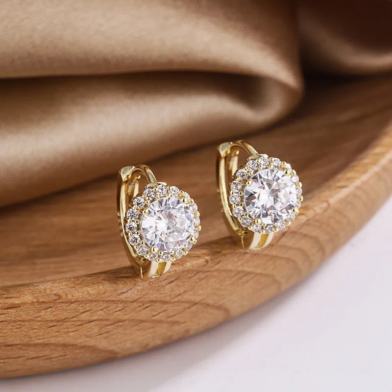 Women's geometric copper earrings with 14K yellow electroplated finish on white background