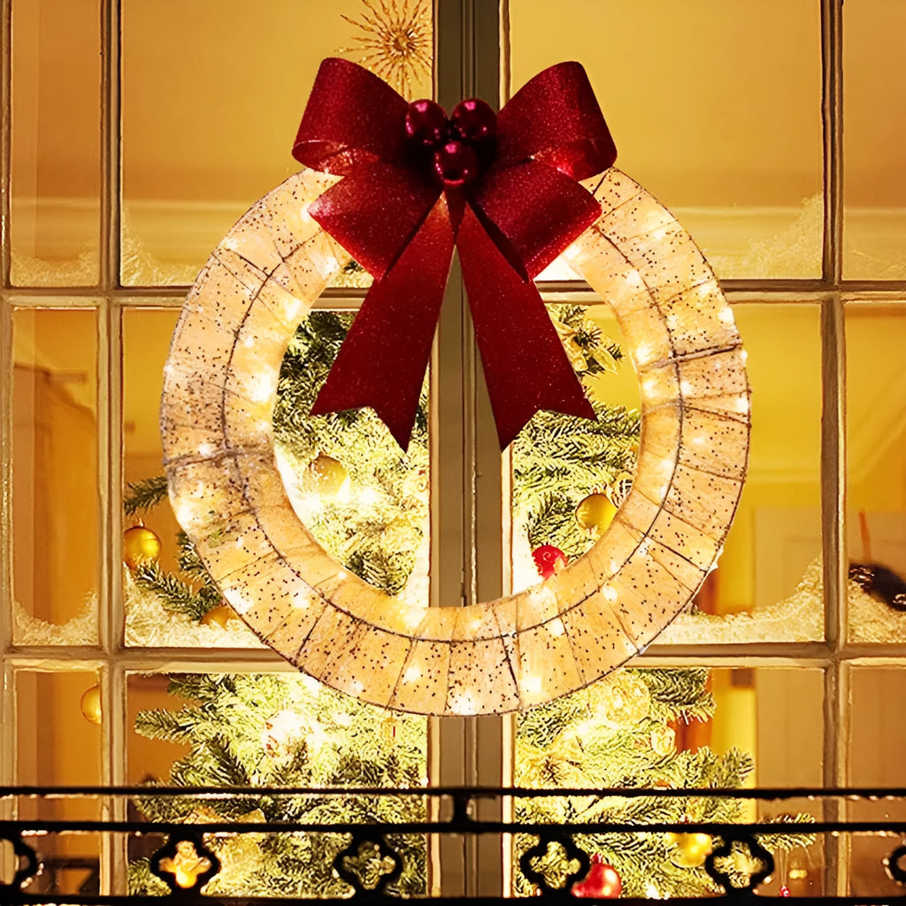 50cm gold green tinsel Christmas garland with LED lights and big bowknot on a wooden door