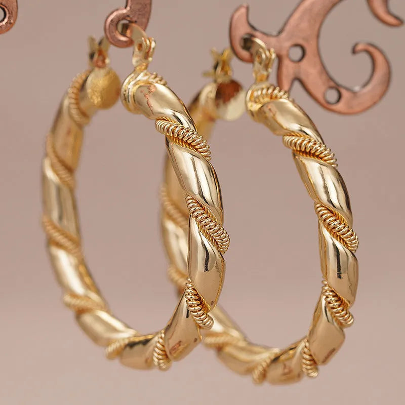 Geometric gold-coloured copper earrings with ring and line design elements
