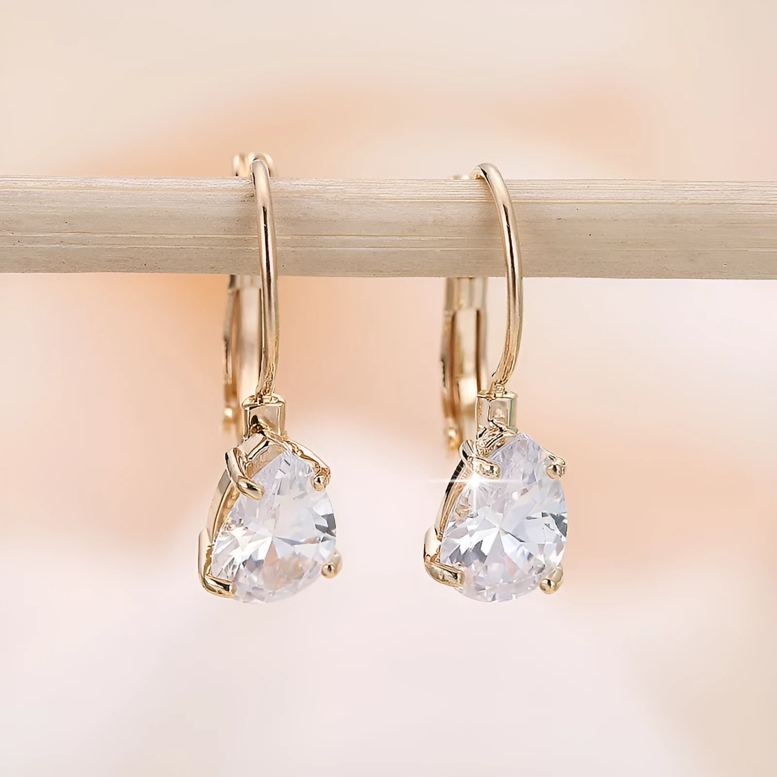 Women's drop-shaped fashion earrings in gold or platinum finish with copper construction