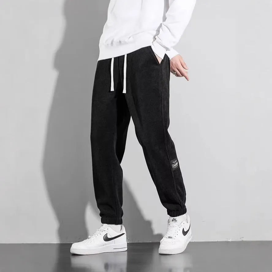 Men's loose straight drapey sweatpants in dark gray with drawstring waist and cotton blend fabric
