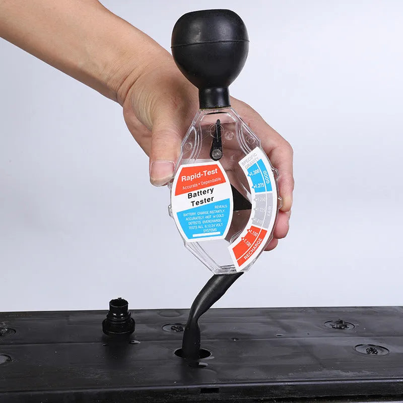 ABS plastic suction electrolyte hydrometer tool for lead-acid battery testing on a workbench.