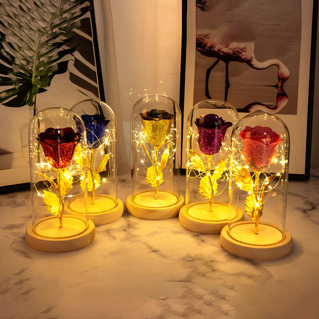 Glass dome covering a red eternal rose with coiled battery-powered LED lights on bendable copper wire.