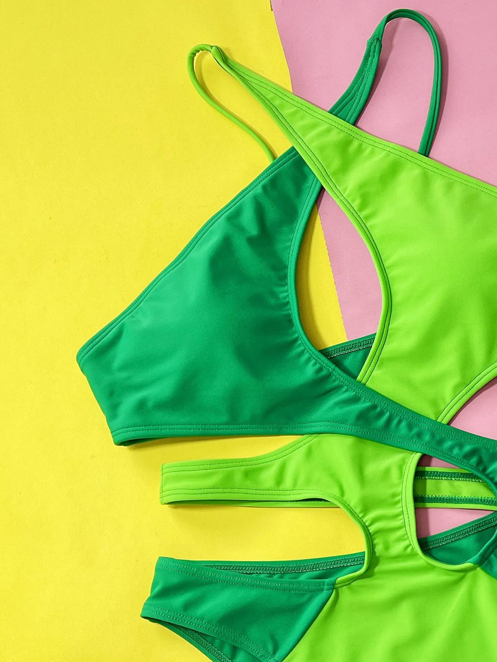 Green women's one-piece swimsuit with hollow contrast colour design