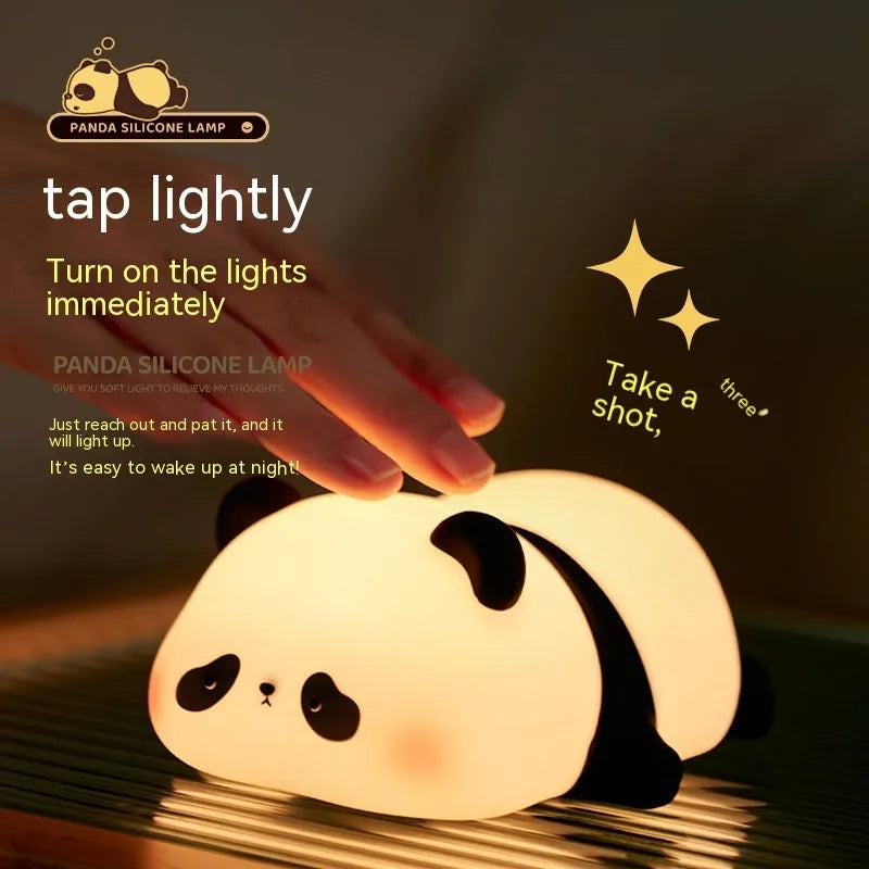 Cute cartoon panda silicone night light for children on a bedside table.