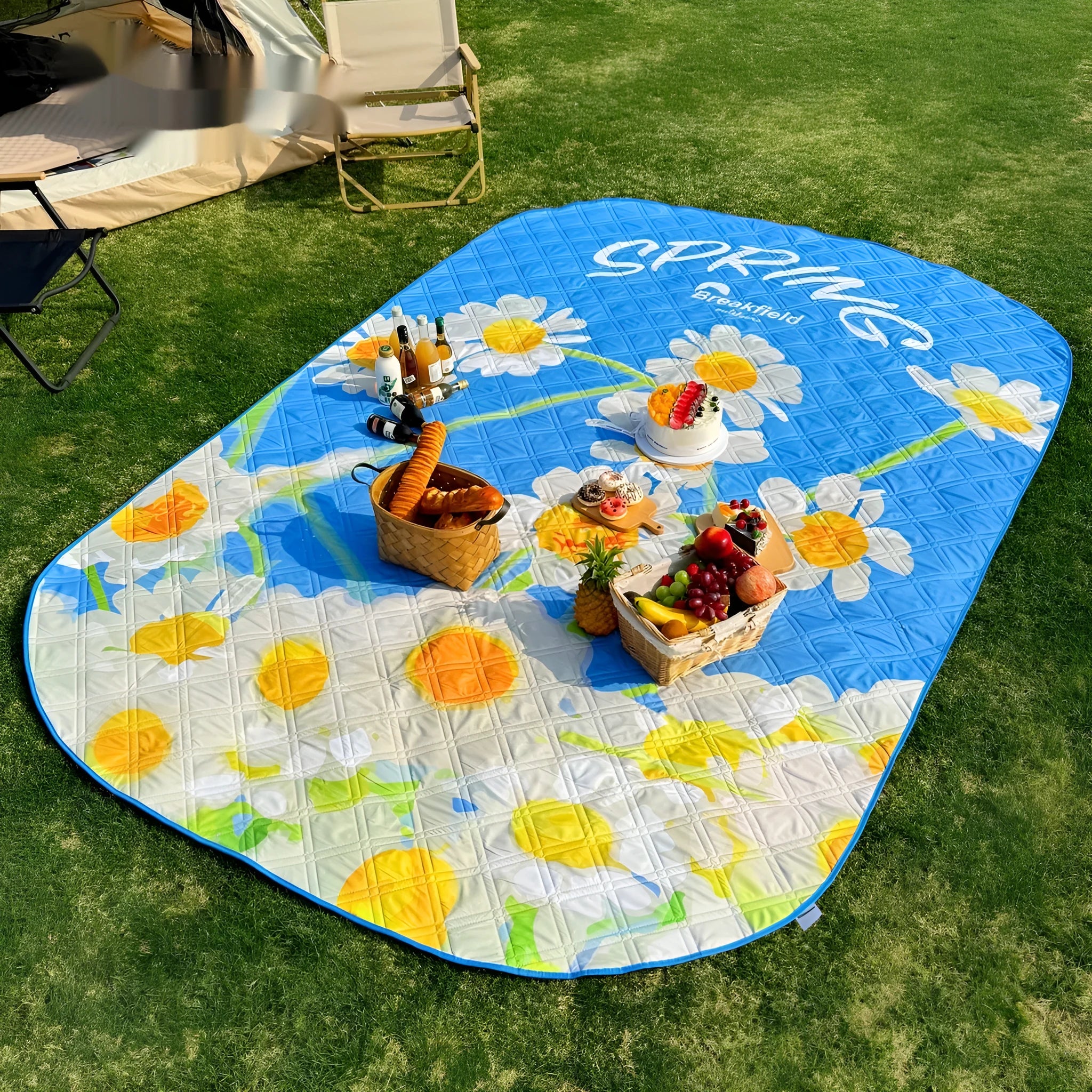 Large green waterproof picnic mat laid out on grass, showing its textured brushed fabric and size for multiple people.