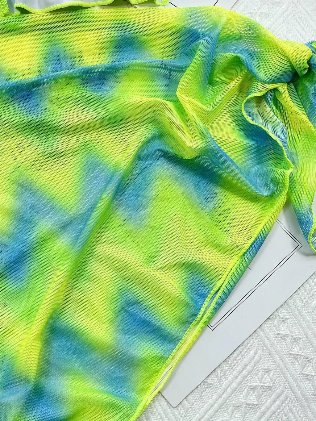 Green tie-dyed women's bikini swimsuit set with bra, pants, and skirt cover-up