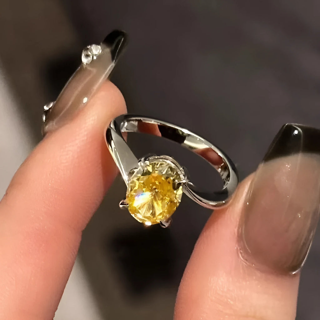 Women's copper ring with a bright yellow crystal sugar finish on a finger.