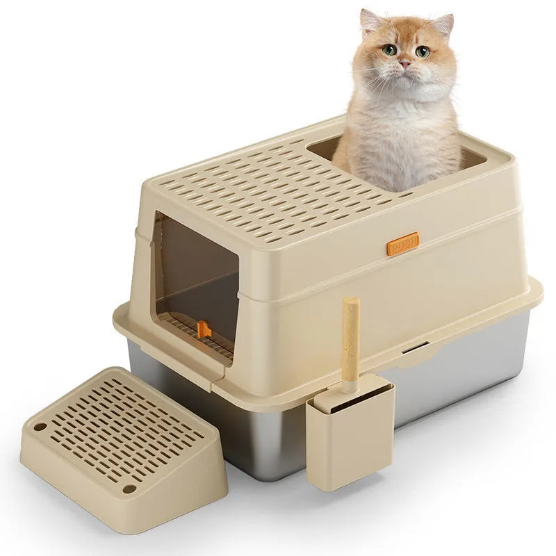 Grey fully enclosed hooded cat litter box with a foot pedal next to the front entrance door.