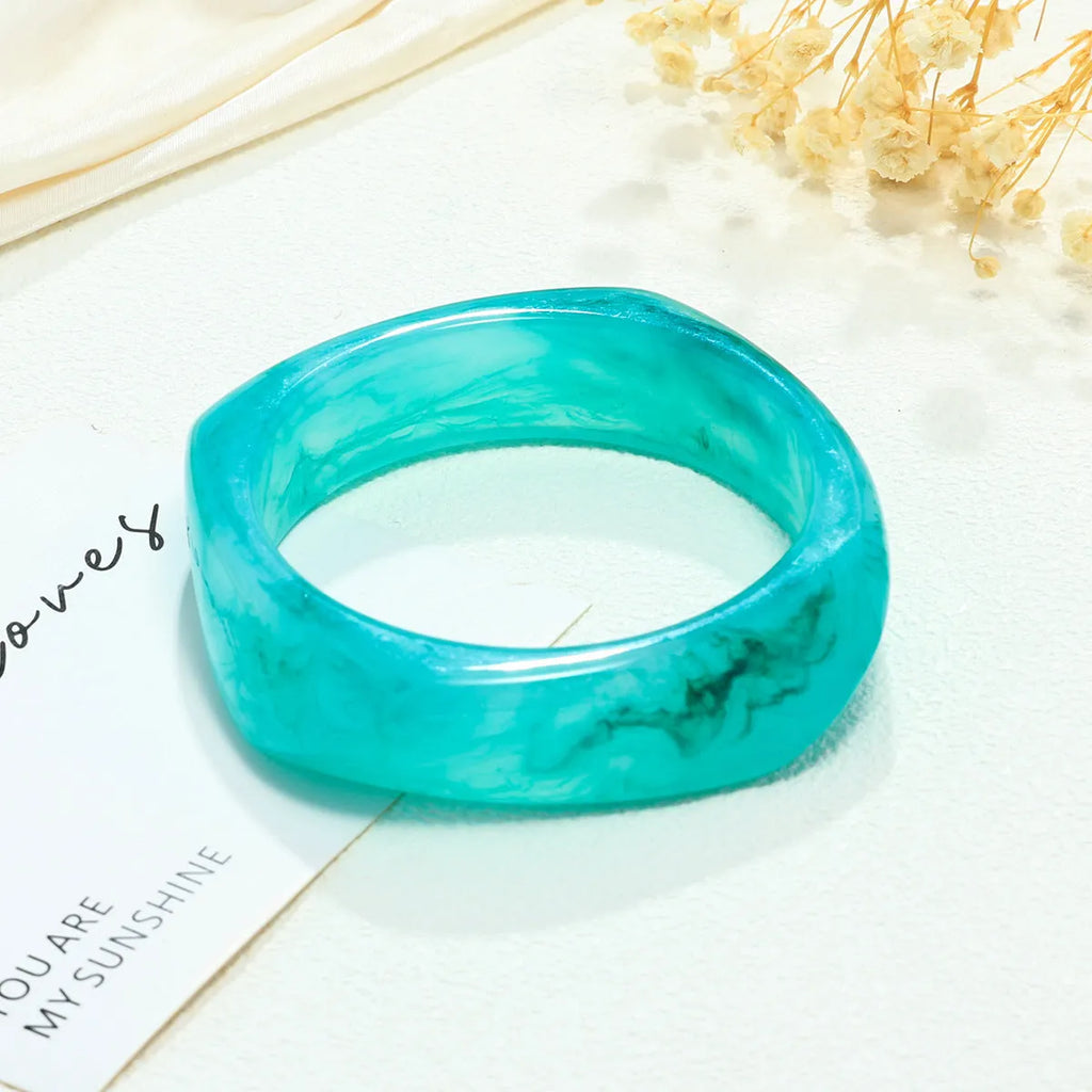 Resin arc bracelet in coffee colour with geometric blooming design and electroplating finish