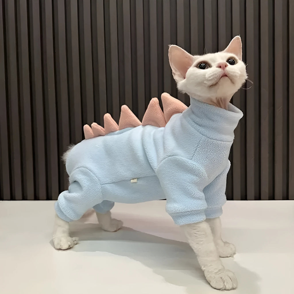 Sphynx cat wearing dinosaur costume with fleece material and tail spikes