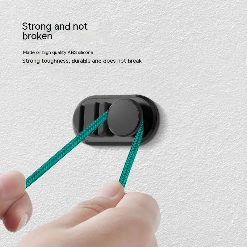 Compact dark green ABS silicone data cable storage hook for car or home use.