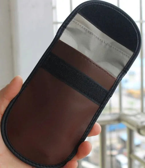 Black microfiber Faraday cage key fob bag for blocking mobile phone signals and RFID scanning