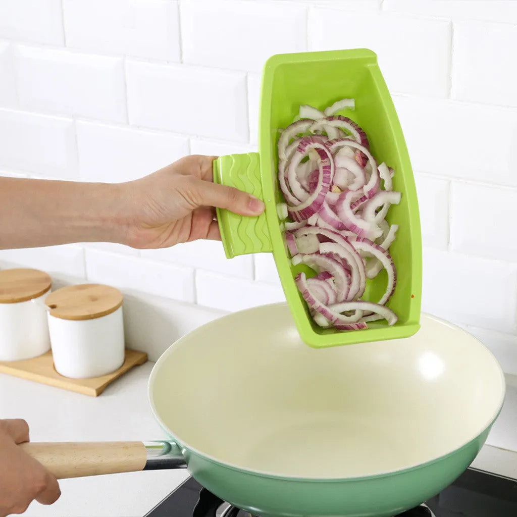 Green sink-mounted kitchen cutting board with drain holes and a storage trough for vegetables.