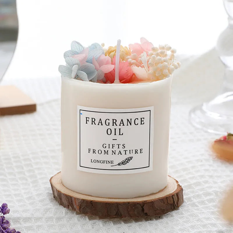 Aromatherapy candle with dried flowers embedded in the wax, shown next to its optional gift box packaging.