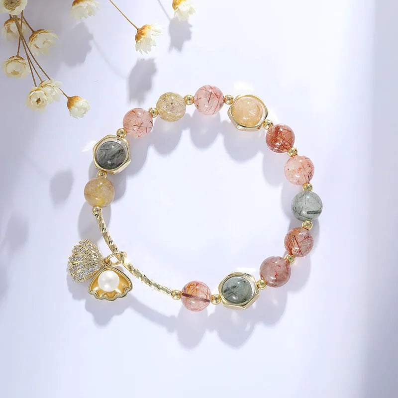 Colourful crystal shell bracelet with red sealant flower designs and animal zodiac motifs