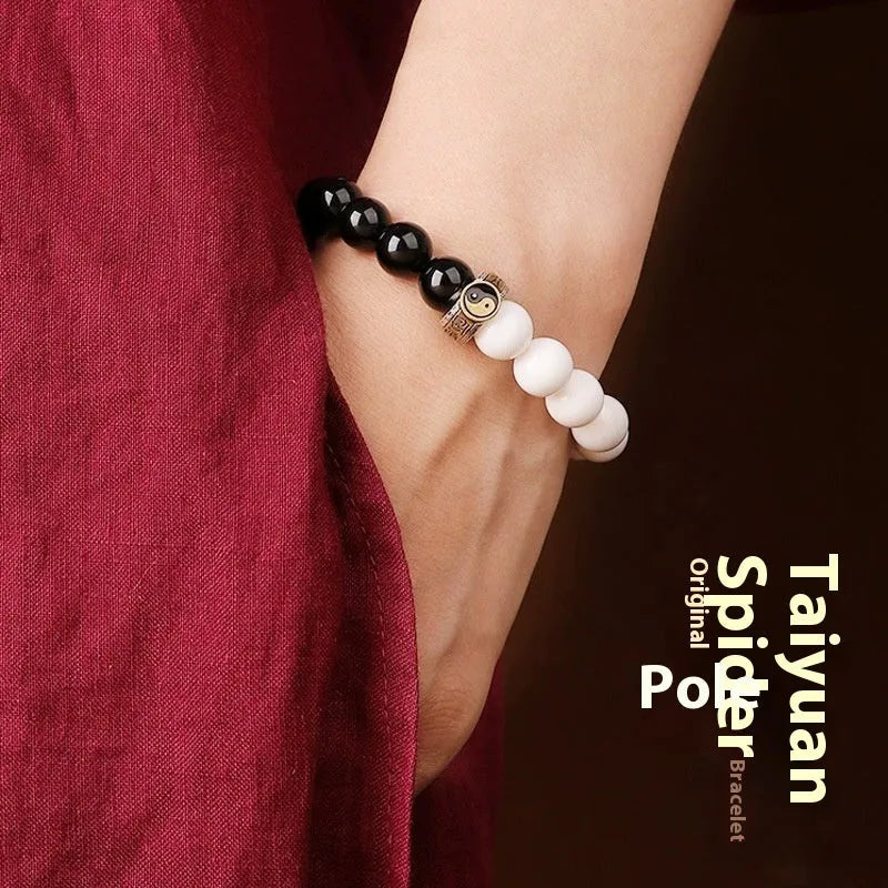 Black and white obsidian bracelet with taiji symbol and mantra bead