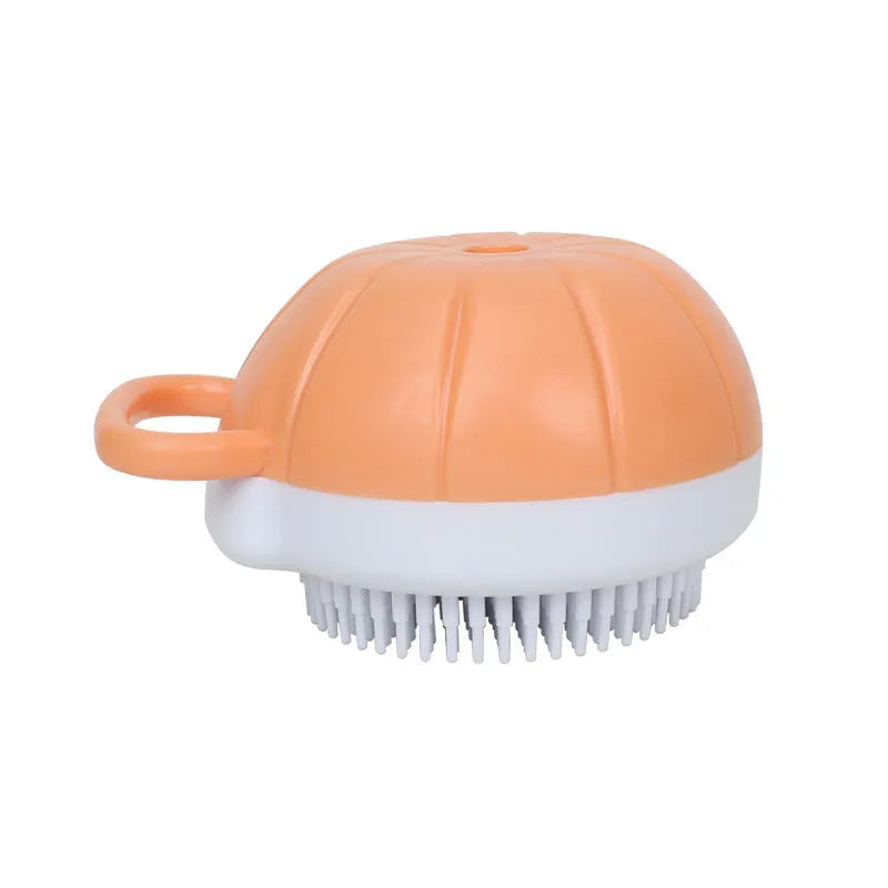 Orange dog bath brush with shampoo dispenser and soft TPR bristles on a curved pumpkin-shaped handle.