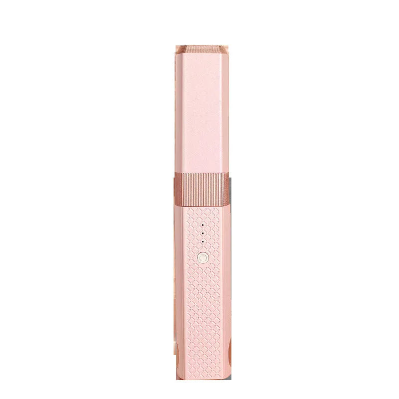 Compact pink cordless USB hair straightener and curler with ceramic plates on a white background.