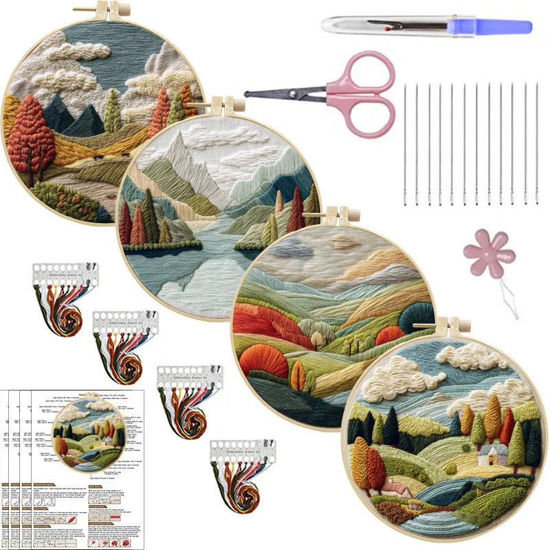 DIY embroidery kit components: printed cotton landscape fabric, embroidery threads, needles, and a bamboo hoop.