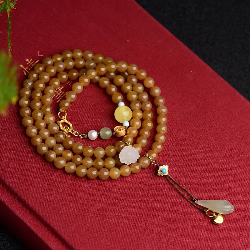 Women's natural bracelet with green pine beads, jade leaves, and beeswax accents