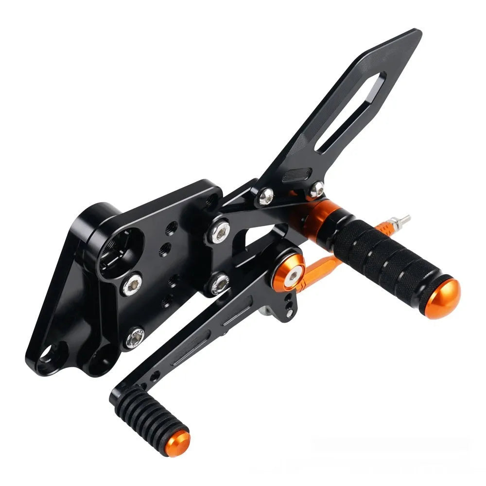 KTM Duke foot pedal bracket assembly for raised rear shift pedal in black or orange