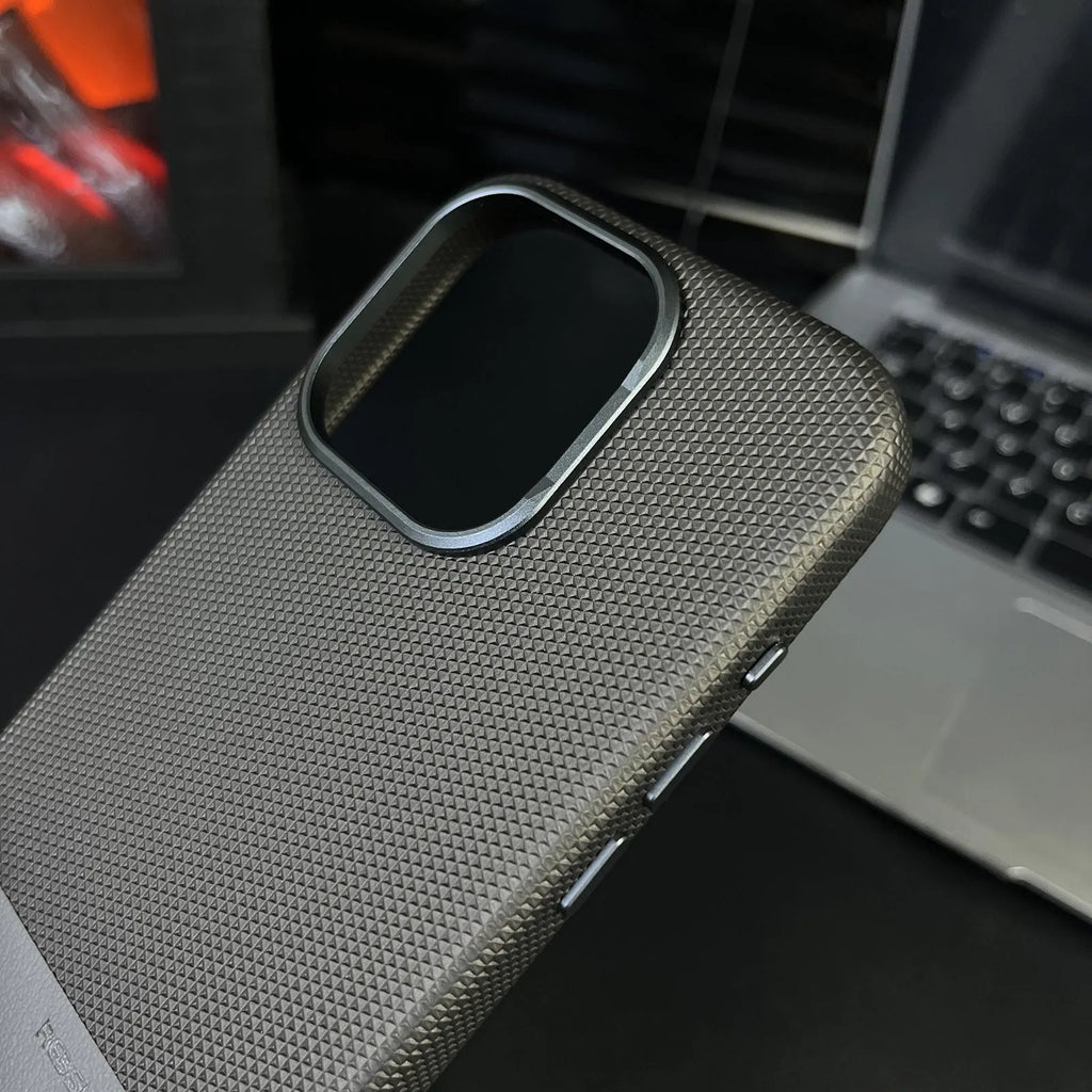 Black iPhone case with dragon scale texture and leather stitching, showing built-in magnetic ring on the back.