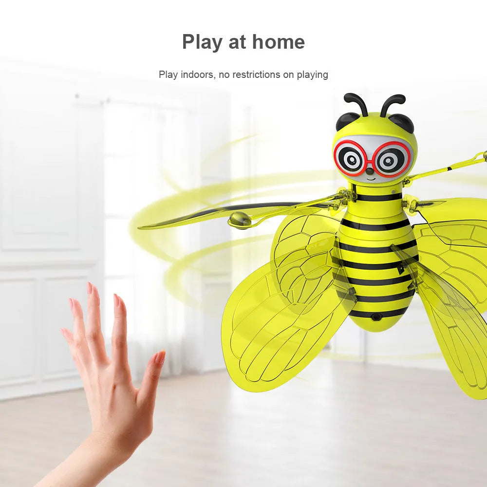 Yellow mini flying ball bee drone with infrared gesture sensing, ABS plastic body, and removable wings on a white background