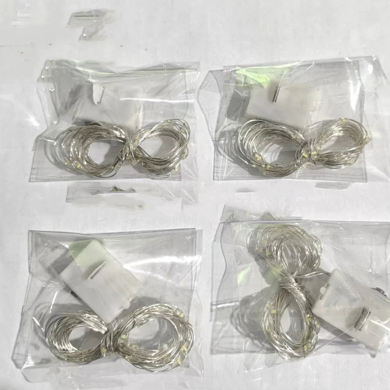 LED copper wire light in small white box with three-gear adjustment and 0.2m chain of four warm white LEDs
