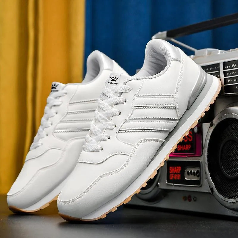 Men's black leather casual sports shoes with mesh lining and carved wing pattern design