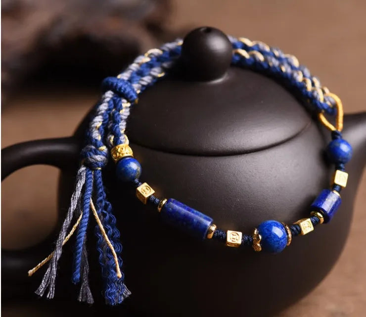 Close-up of a hand-woven flexible wire bracelet for women with a Lapis Lazuli stone accent.