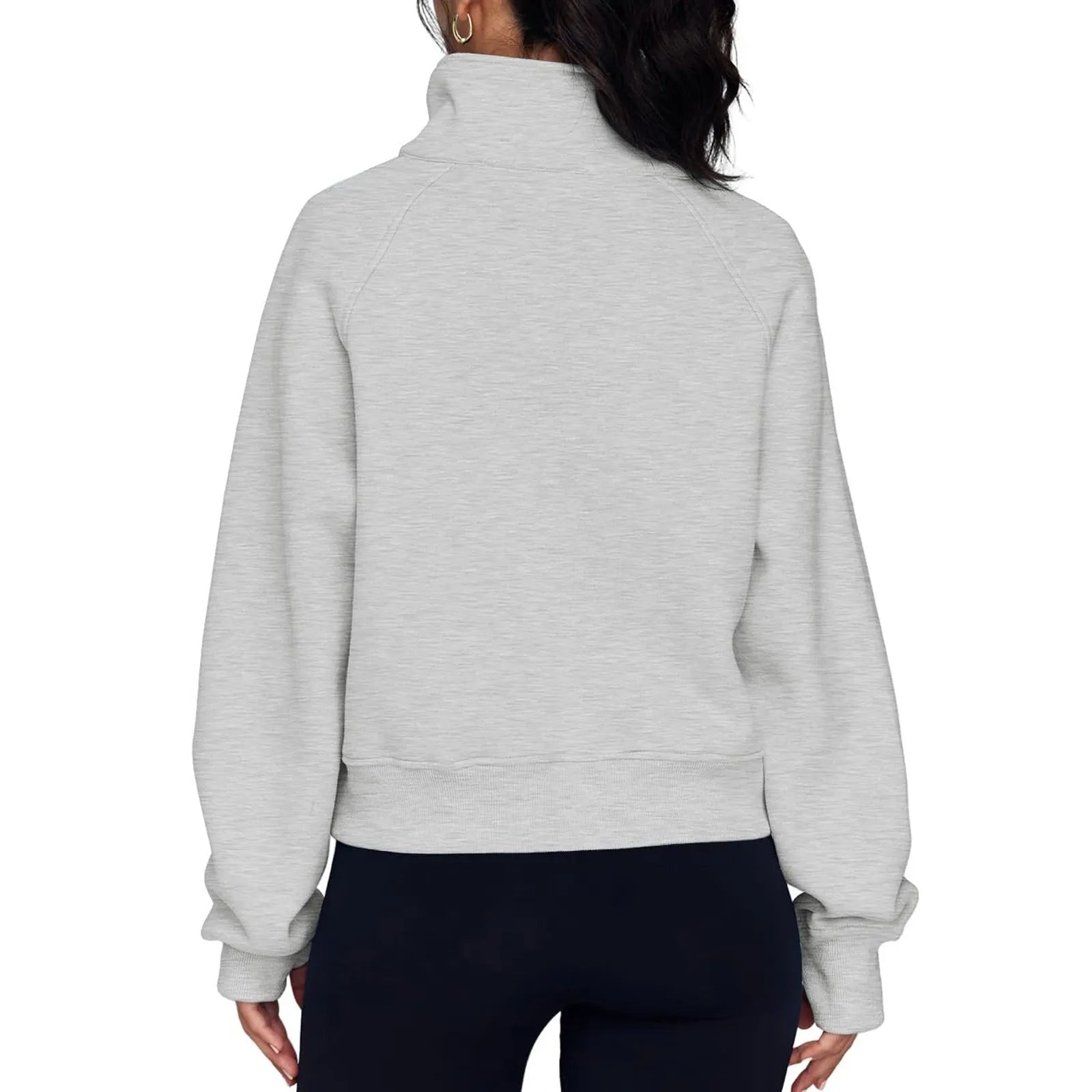 Woman wearing a loose lapel fleece-lined sweater in a solid colour, showing raglan sleeve detail.