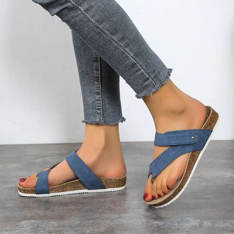 A pair of solid-colour flat toe ring flip-flops with a thick foam sole, shown in blue.