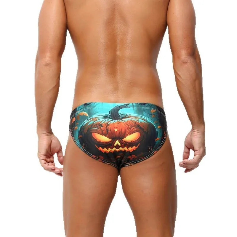Man wearing grey low waisted digital print polyester shorts, showcasing the briefs fit and graphic design.