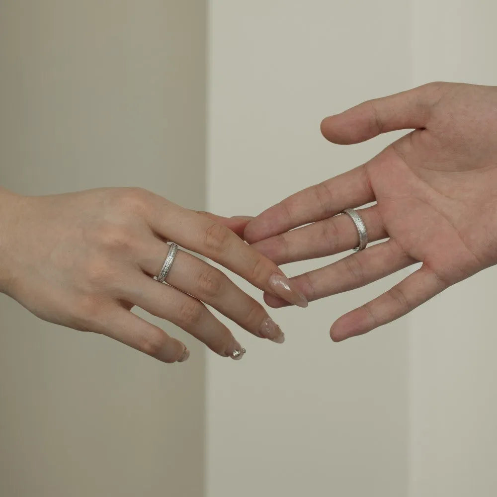 S925 sterling silver couple ring with geometric shape and platinum electroplated finish on neutral background