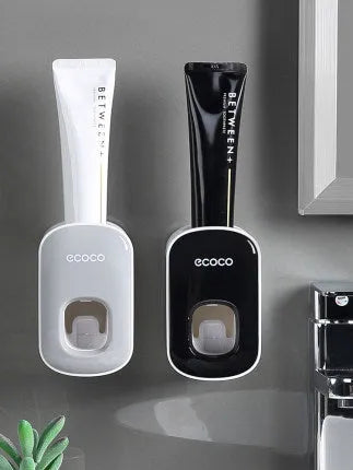 Black wall-mounted automatic toothpaste holder with toothbrush storage and suction cup mounting