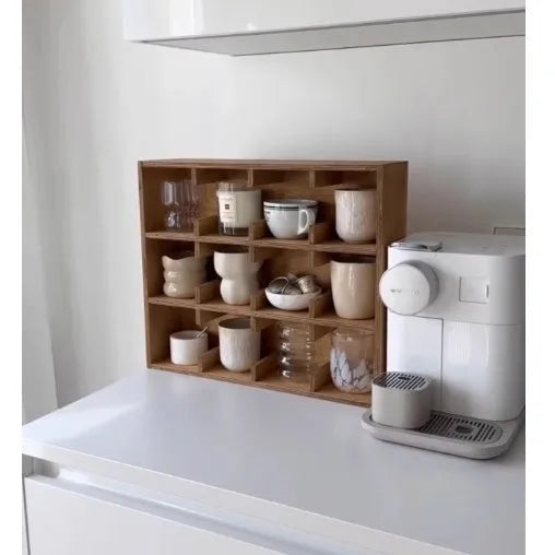 Square solid wood cup storage rack with multiple grids in natural birch wood colour.