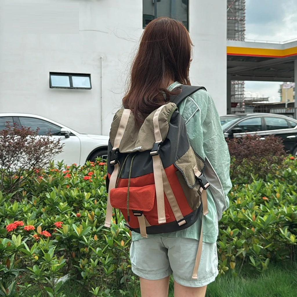 Orange and green contrast colour outdoor backpack with multiple compartments and air pillow belt system