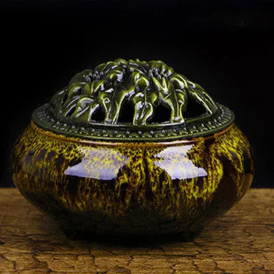 Ceramic incense burner with retro packaging in various colours on wooden surface.