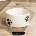 Ceramic cat bowl with oblique mouth and high foot in cat's paw black colour