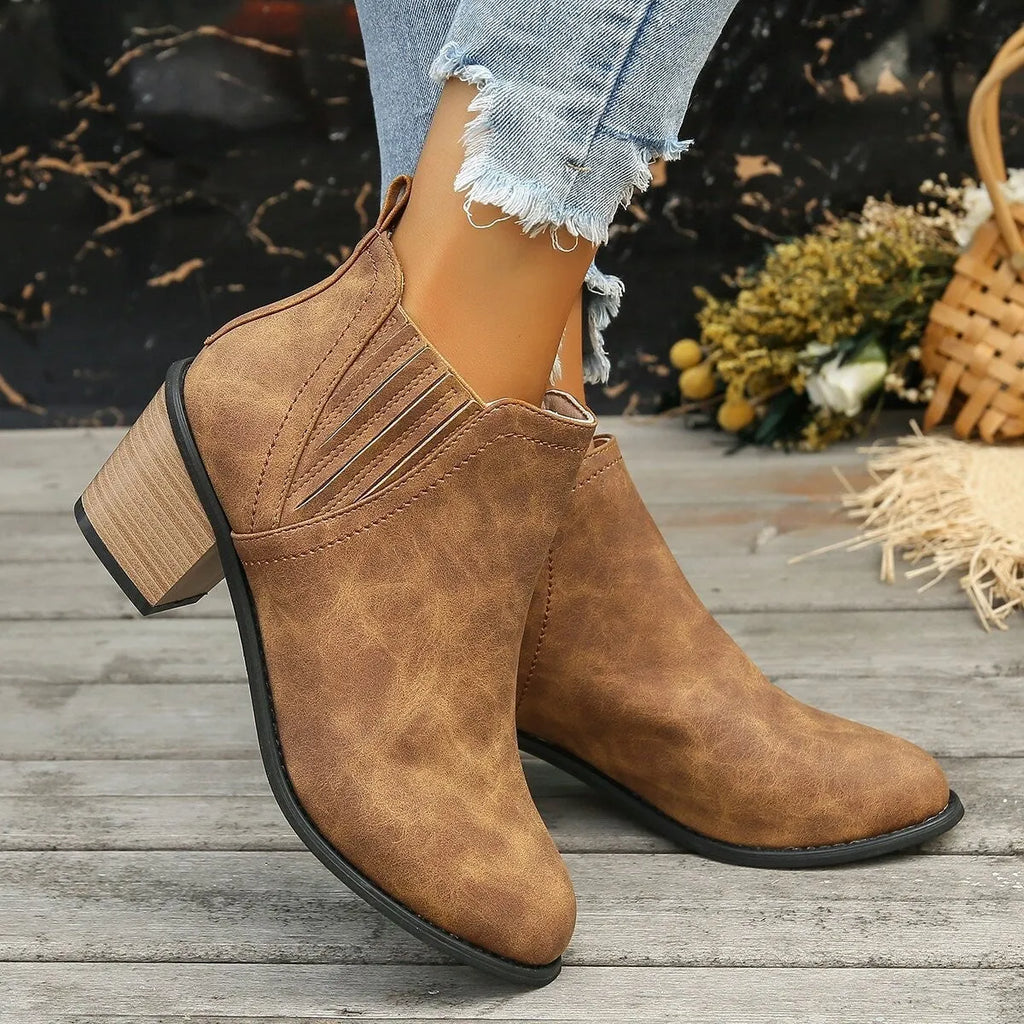 Women's black ankle boots with pointed toe and thick square heel, slip-on design