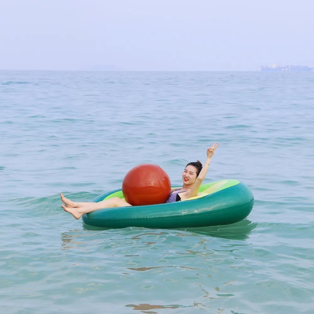 Green avocado-shaped inflatable pool float with dimensions 169cm by 130cm.