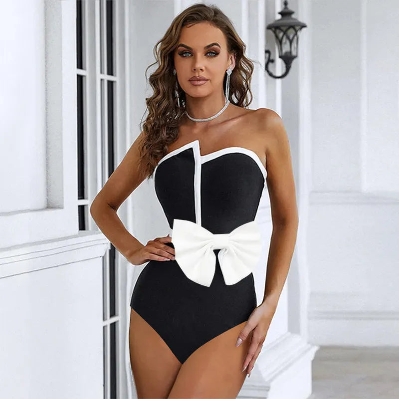 Women's black and white colour-block one-piece swimsuit with asymmetric bow detail