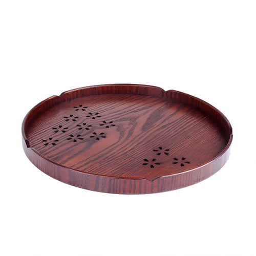 12 wooden circular plates with sakura flower cut-out designs arranged with storage tray