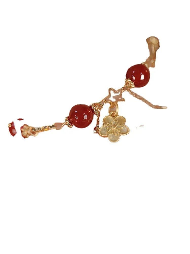 Red agate double layer bracelet with peach blossom floral details on woman's wrist
