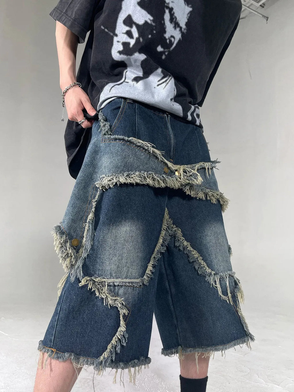 Blue denim shorts with frayed detailing and five-pointed star design in loose fit style