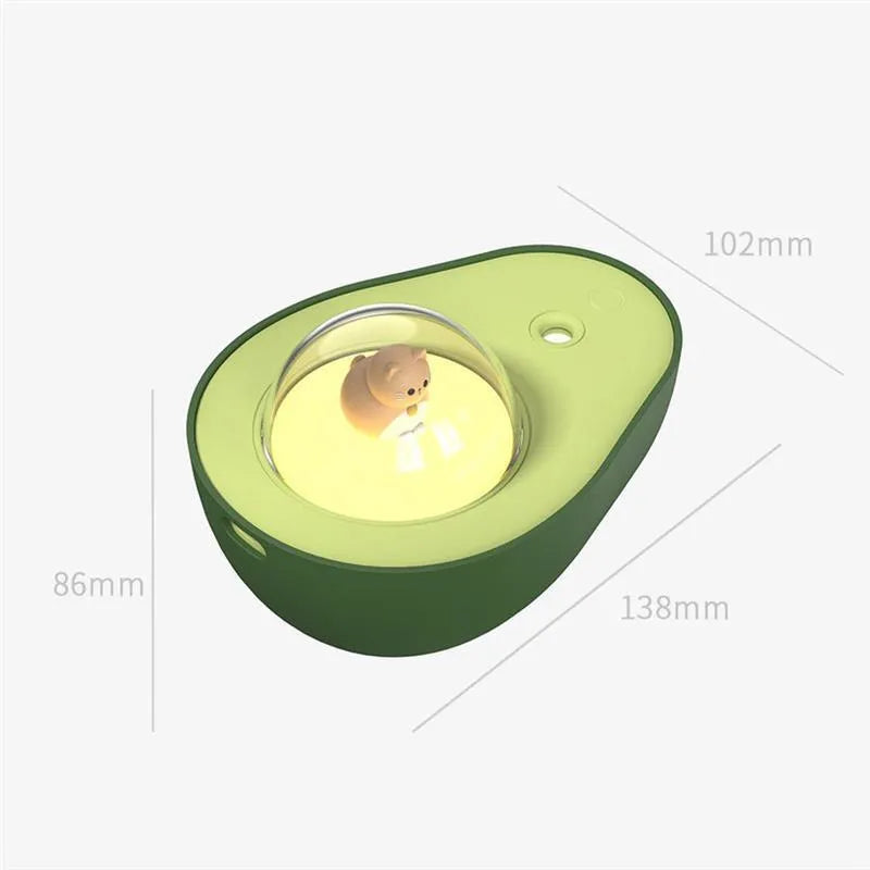 Green avocado-shaped mini USB humidifier with night light on a desk
